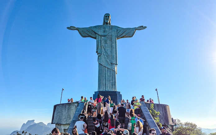 Tourists gather at the base of Christ the Redeemer statue in Rio de Janeiro, Brazil.