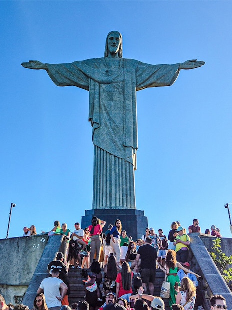 Tourists gather at the base of Christ the Redeemer statue in Rio de Janeiro, Brazil.