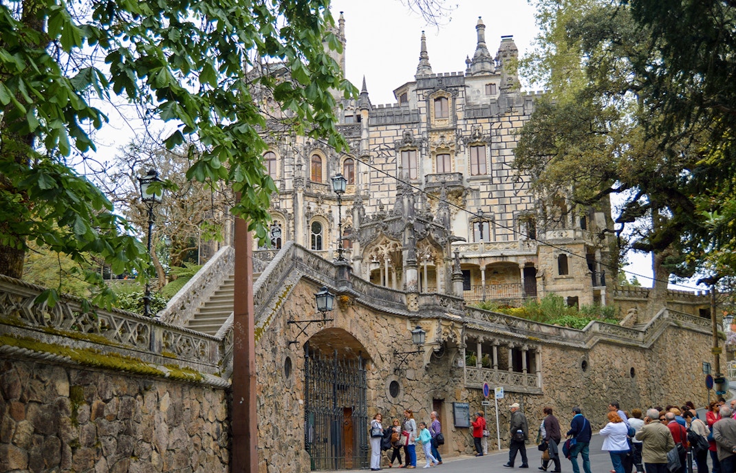 Quinta Da Regaleira castle entrance in Lisbon with intricate stone carvings.