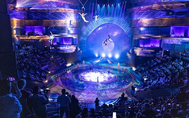 Acrobats performing above a water stage at La Perle by Dragone, UAE.