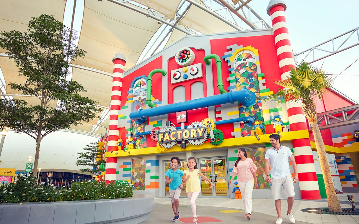 Family walking outside LEGO Factory at LEGOLAND Dubai.