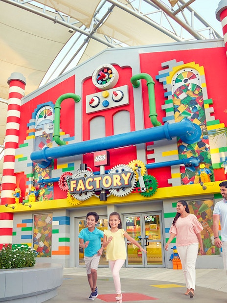 Family walking outside LEGO Factory at LEGOLAND Dubai.