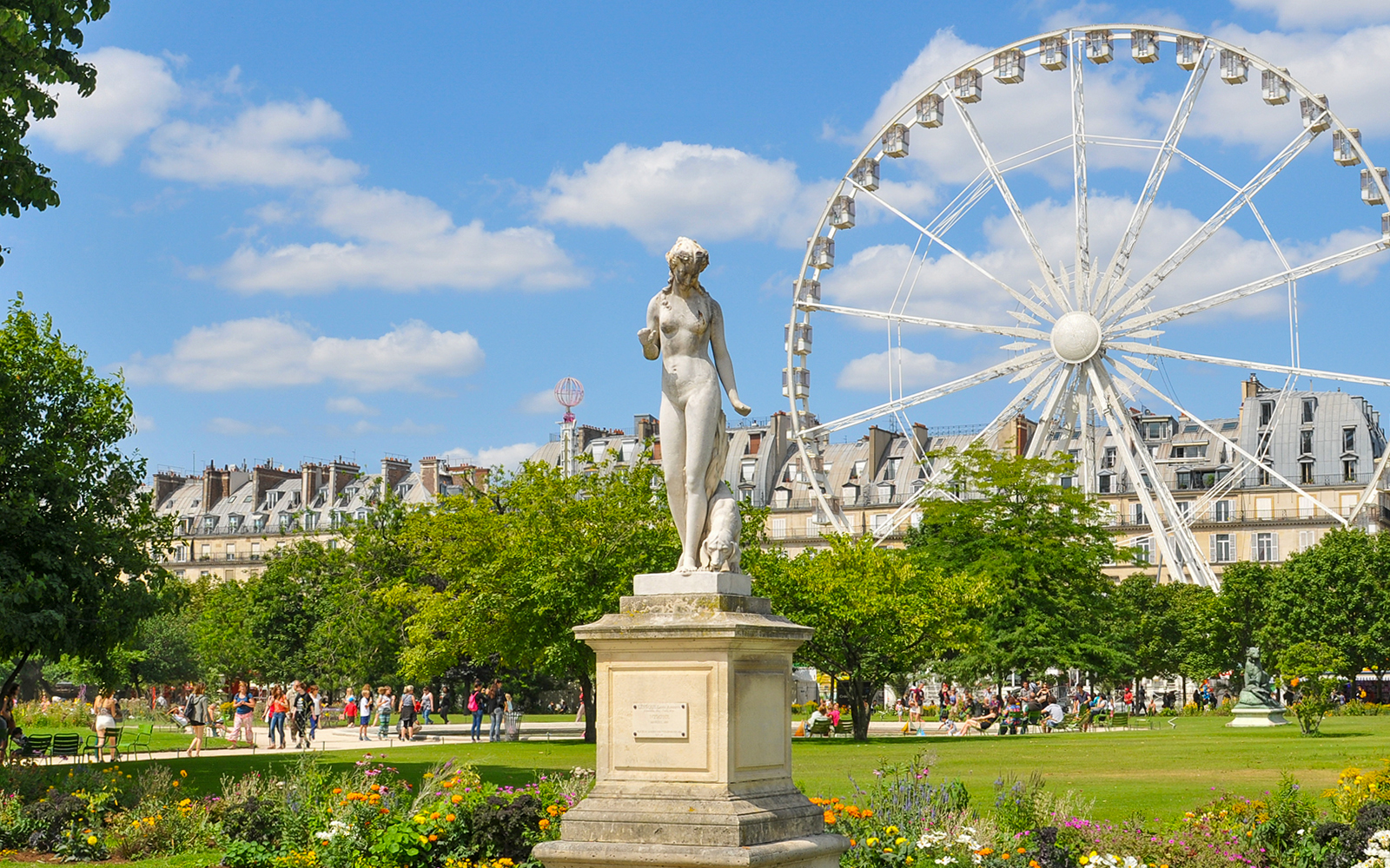 Tuileries Gardens statues and manicured lawns in Paris, France.