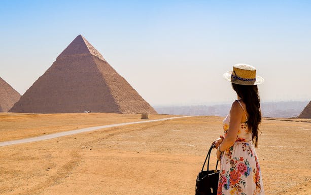 Tourist viewing the Pyramids of Giza on a guided tour in Egypt.
