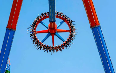 Guests on Crazanity ride at Six Flags Mexico against blue sky.