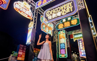 Colorful neon signs at night in Ngong Ping Village, Lantau Island.