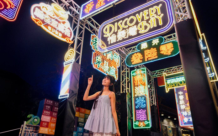 Colorful neon signs at night in Ngong Ping Village, Lantau Island.
