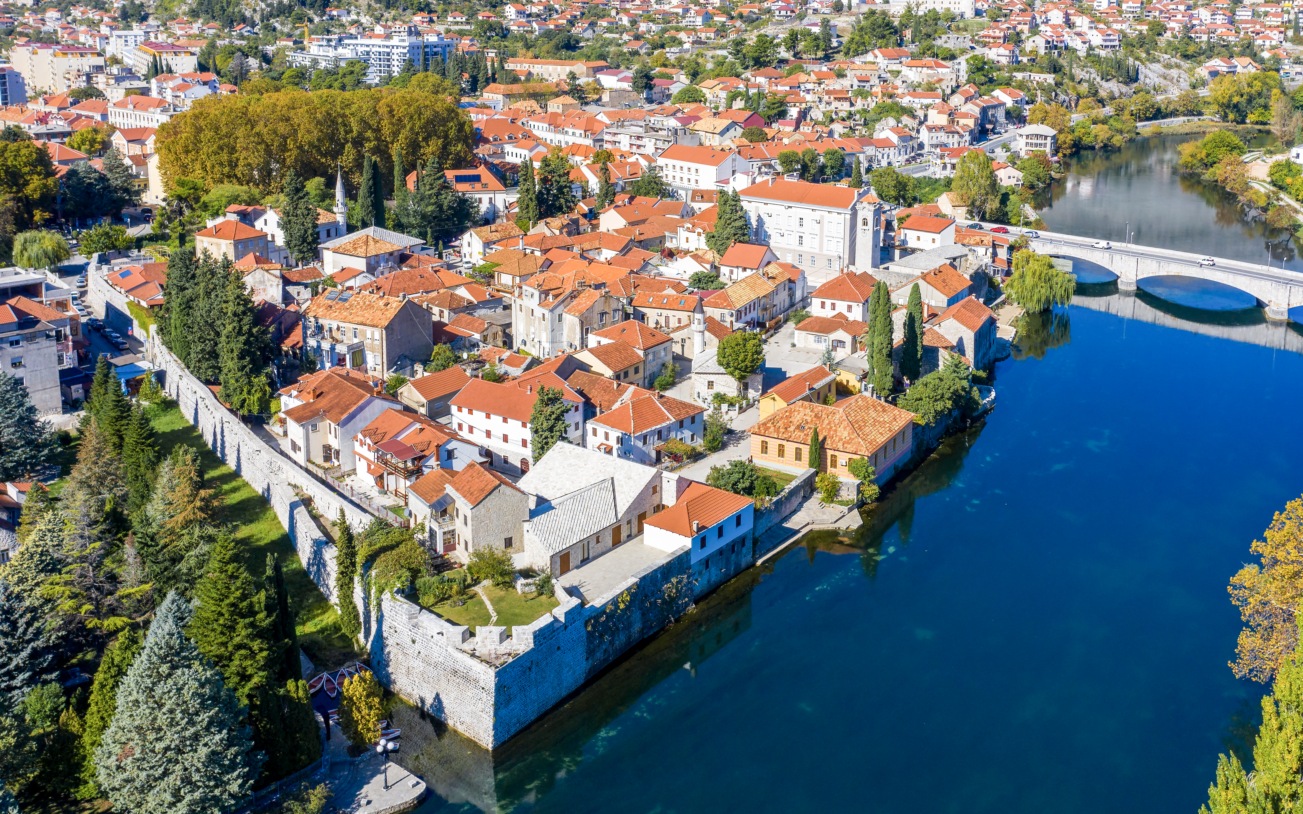 Trebinje old town with red-roofed buildings and Trebišnjica River, Bosnia and Herzegovina.