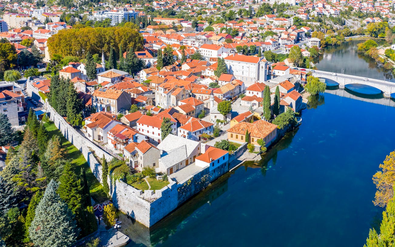 Trebinje old town with red-roofed buildings and Trebišnjica River, Bosnia and Herzegovina.