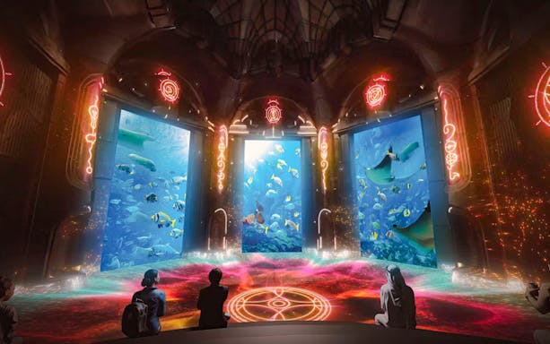 Underwater scene at The Lost World Aquarium with diverse fish and rays.