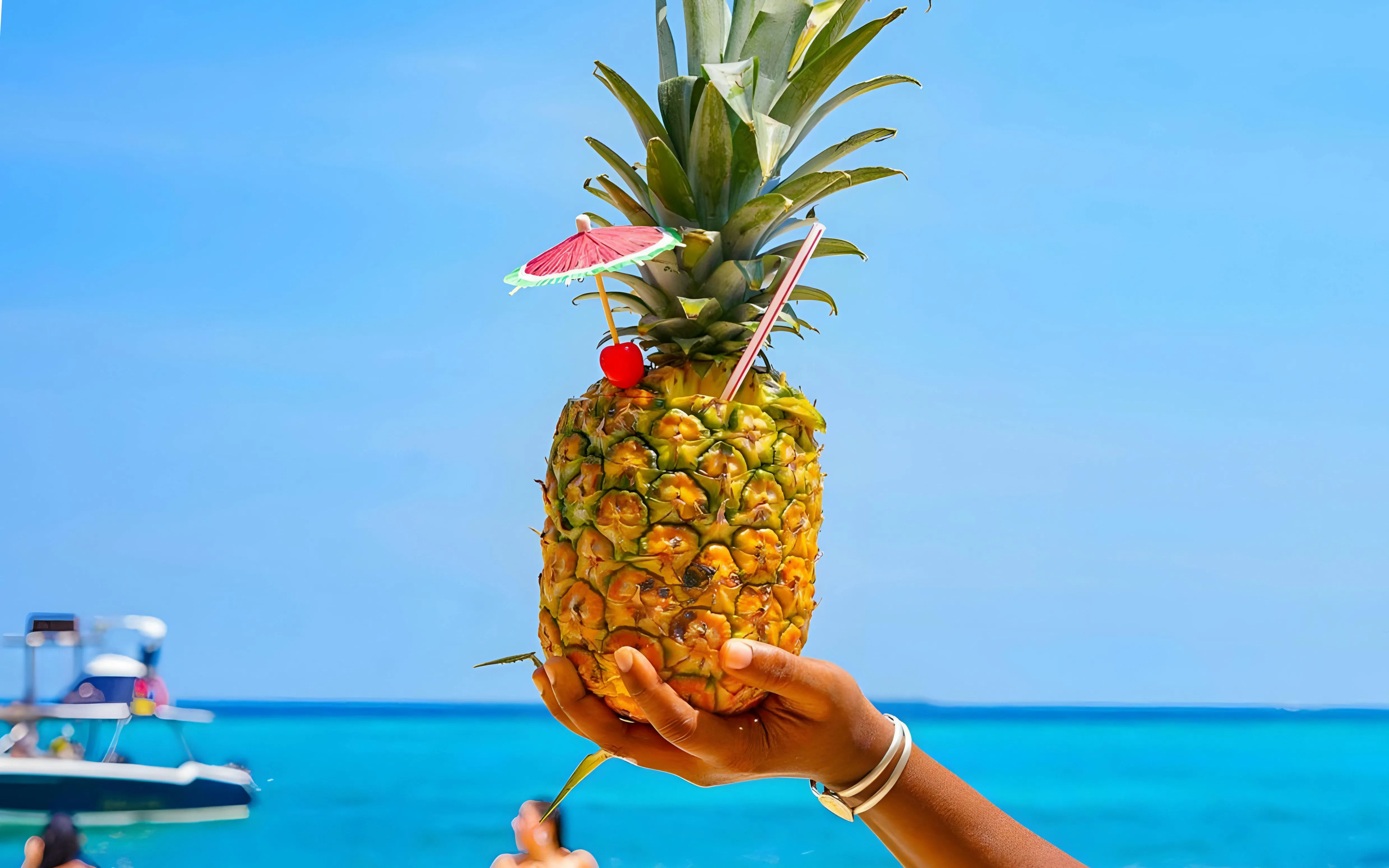 Tropical pineapple drink with umbrella at Rosario Islands, Cartagena, Colombia.