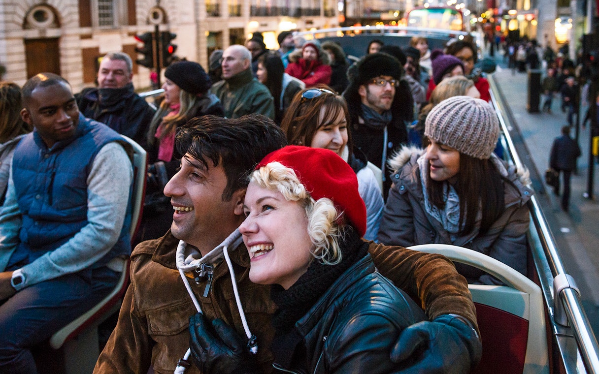 Tourists enjoying the Big Bus London Christmas Lights Night Tour with a live guide.