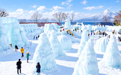 Ice sculptures at Sapporo festival with Mt. Moiwa in background, Hokkaido tour.