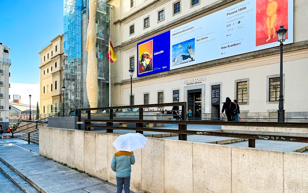 Reina Sofia Museum entrance with visitors in Madrid, Spain.
