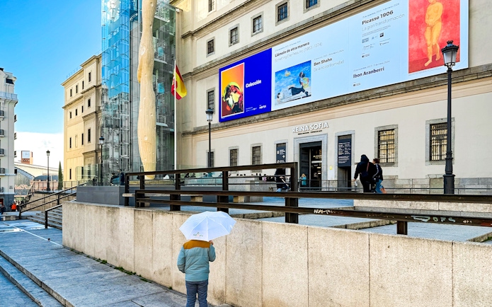 Reina Sofia Museum entrance with visitors in Madrid, Spain.