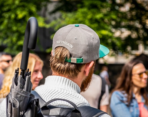 Group of tourists on Edinburgh Harry Potter walking tour near Edinburgh Castle.