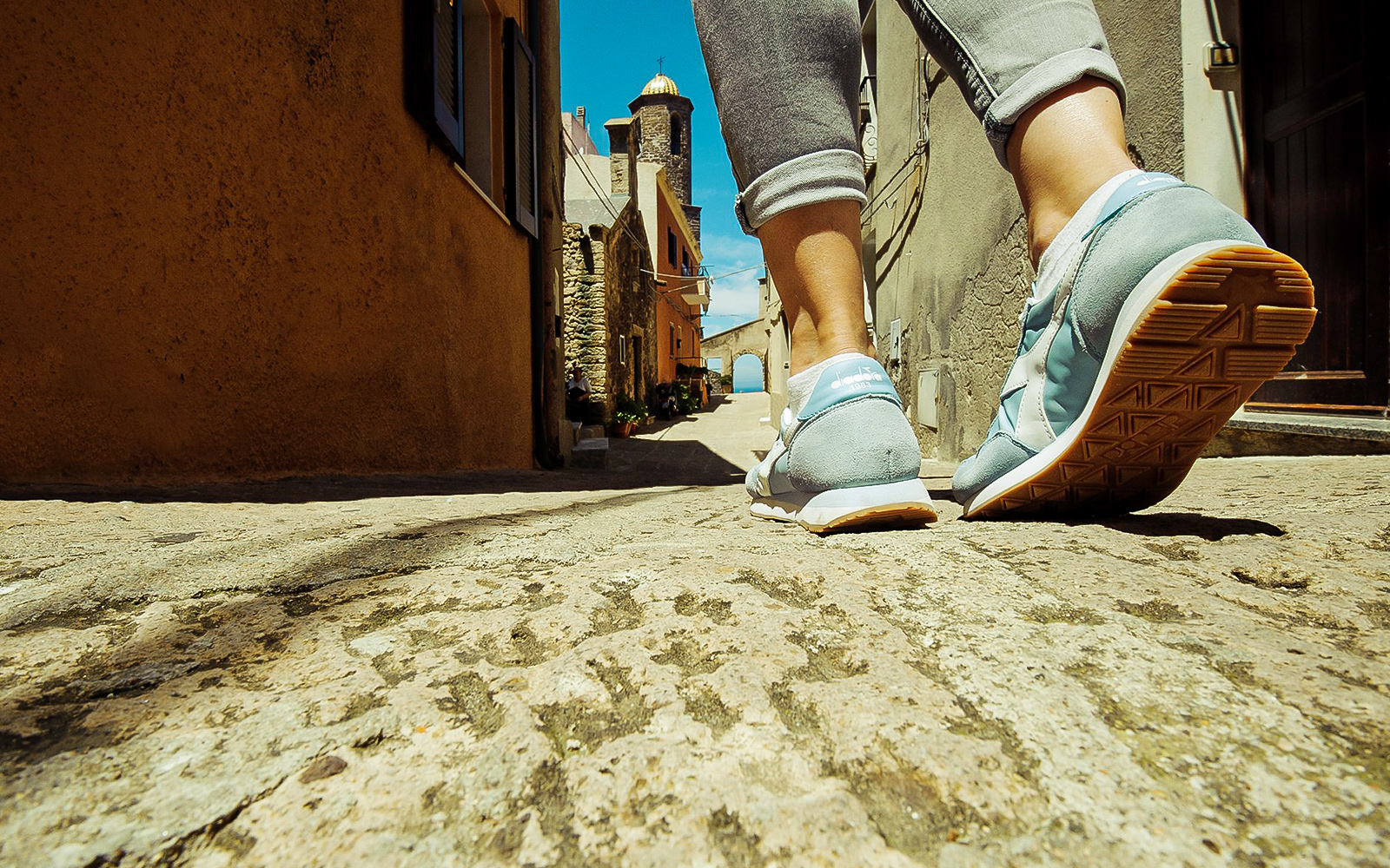 Walking through a narrow street in Castelsardo during a guided tour.