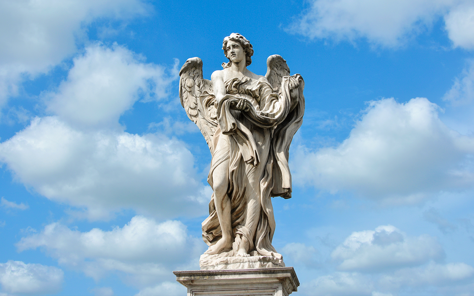 Angel statue holding garment and dice on Ponte Sant'Angelo bridge, Rome.