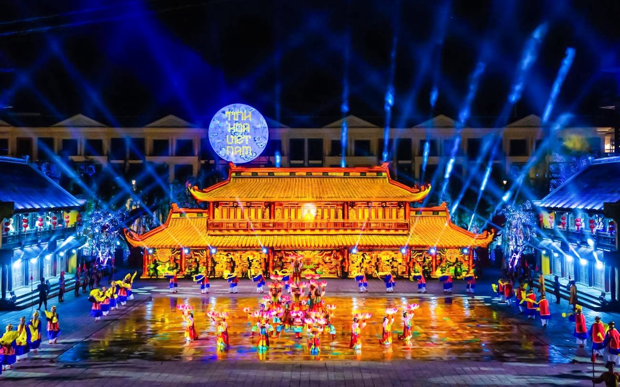 Performers in traditional attire at The Quintessence of Vietnam Show, vibrant stage lighting.
