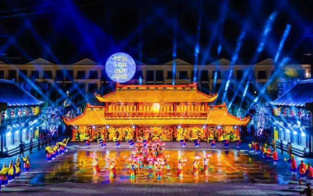 Performers in traditional attire at The Quintessence of Vietnam Show, vibrant stage lighting.