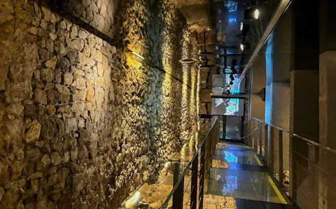 Rynek Underground Museum stone walls and illuminated walkway in Krakow.