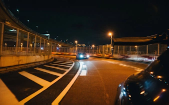 Car drifting on Tokyo highway at night during Fast and Furious experience.