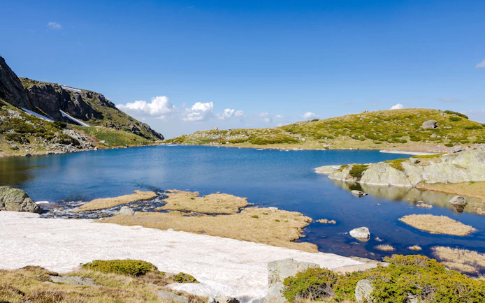 Trefoil Lake in Rila Mountains with clear blue water and surrounding rocky landscape.