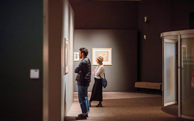 Visitors viewing art at Groeningemuseum, Bruges.