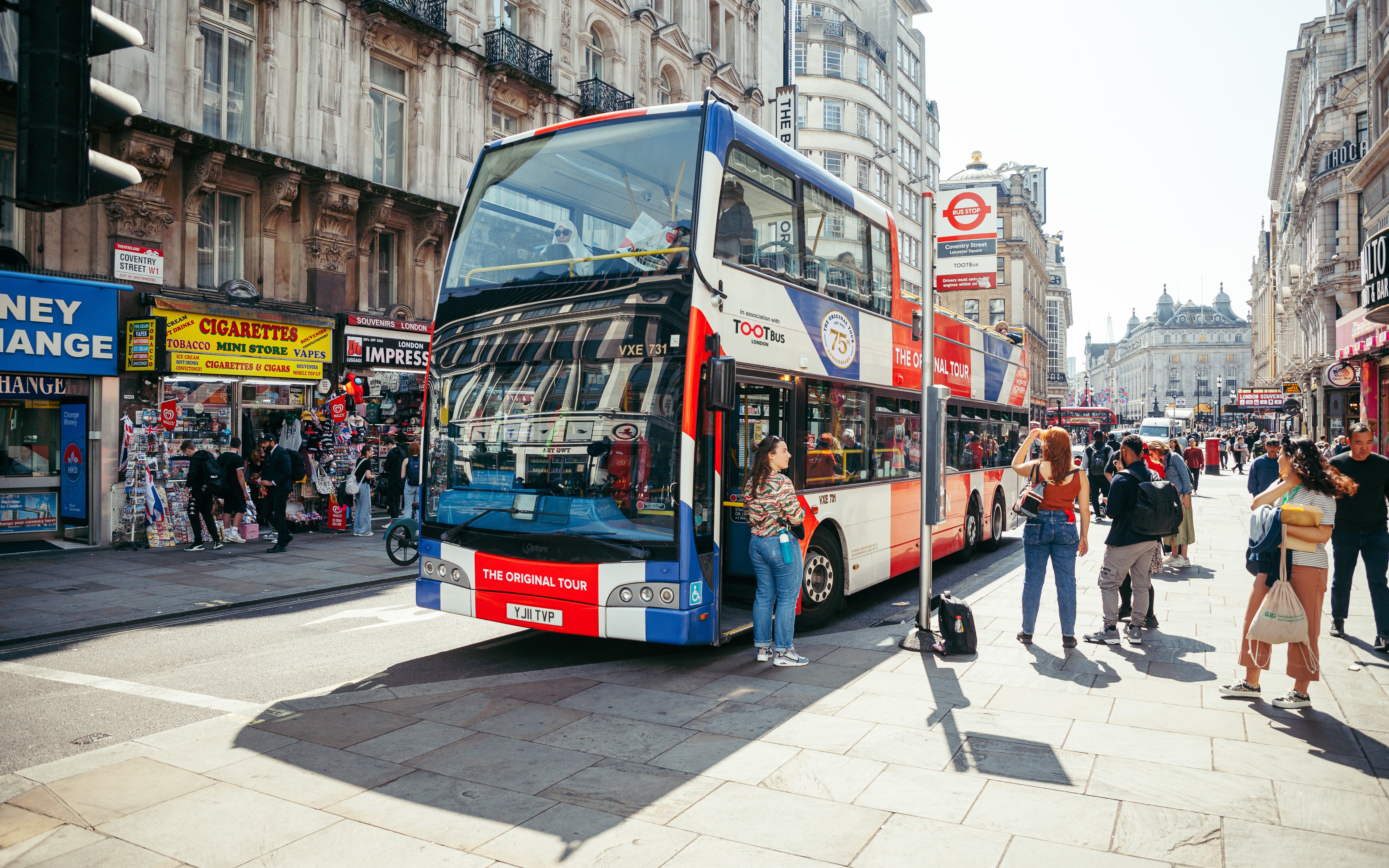 Tootbus London sightseeing bus on a busy street near Coventry Street, London.