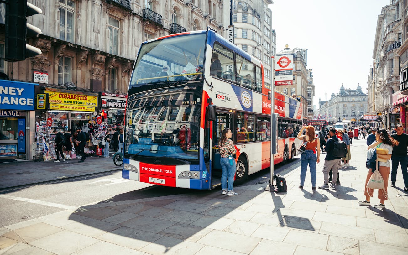 Tootbus London sightseeing bus on a busy street near Coventry Street, London.
