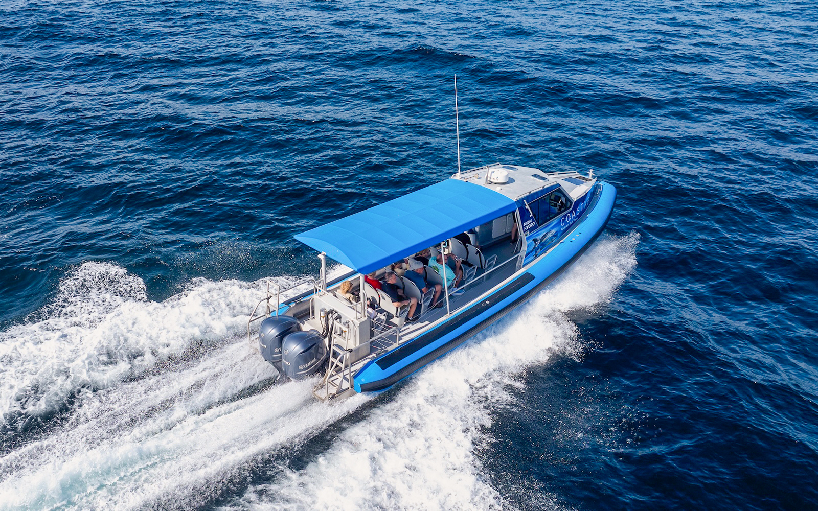 Boat cruising on Lake Macquarie, Australia with passengers onboard.