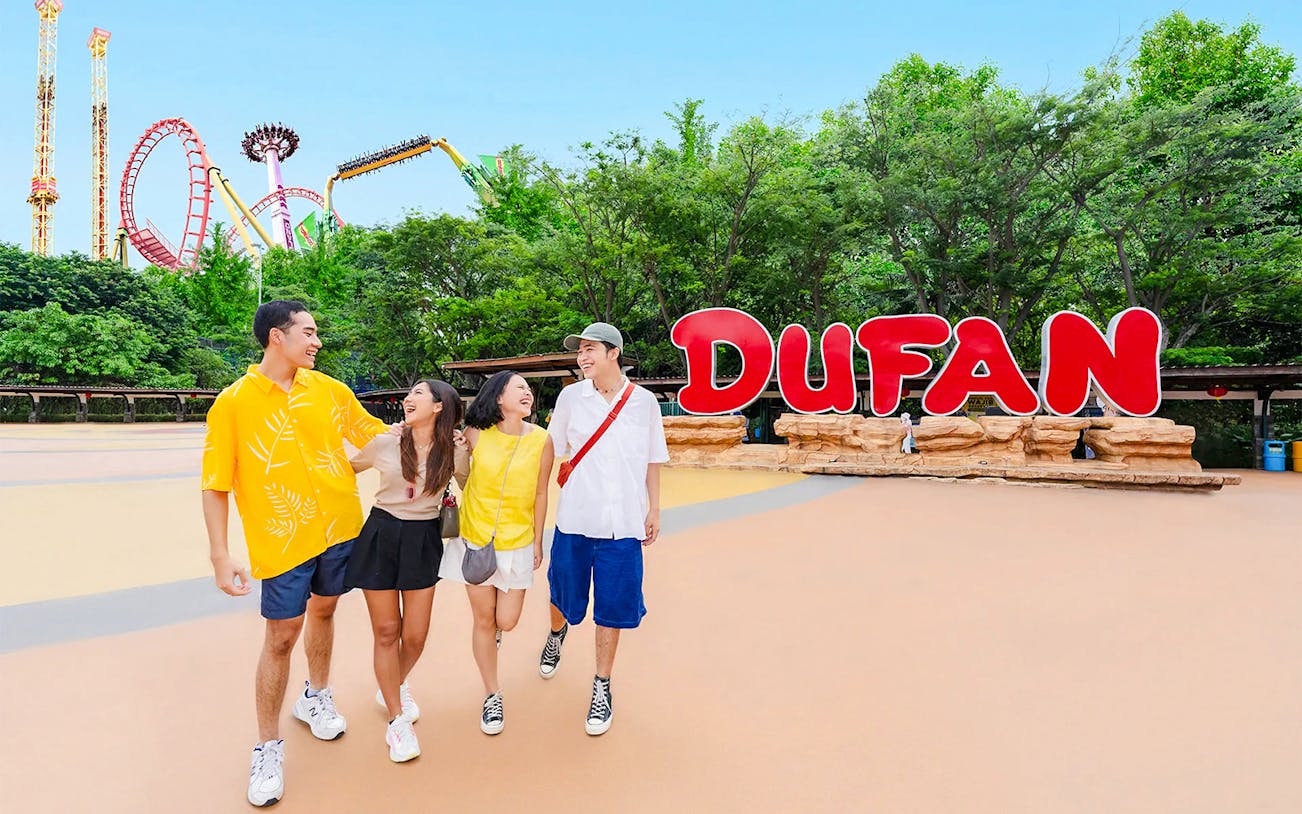 Tourists walking near Dufan sign at Dunia Fantasi Amusement Park, Jakarta.