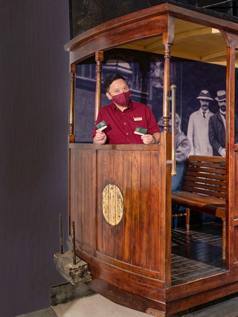 Tourist on The Peak Tram in Hong Kong holding tickets for Sky Terrace 428 experience.