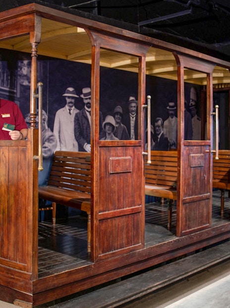 Tourist on The Peak Tram in Hong Kong holding tickets for Sky Terrace 428 experience.