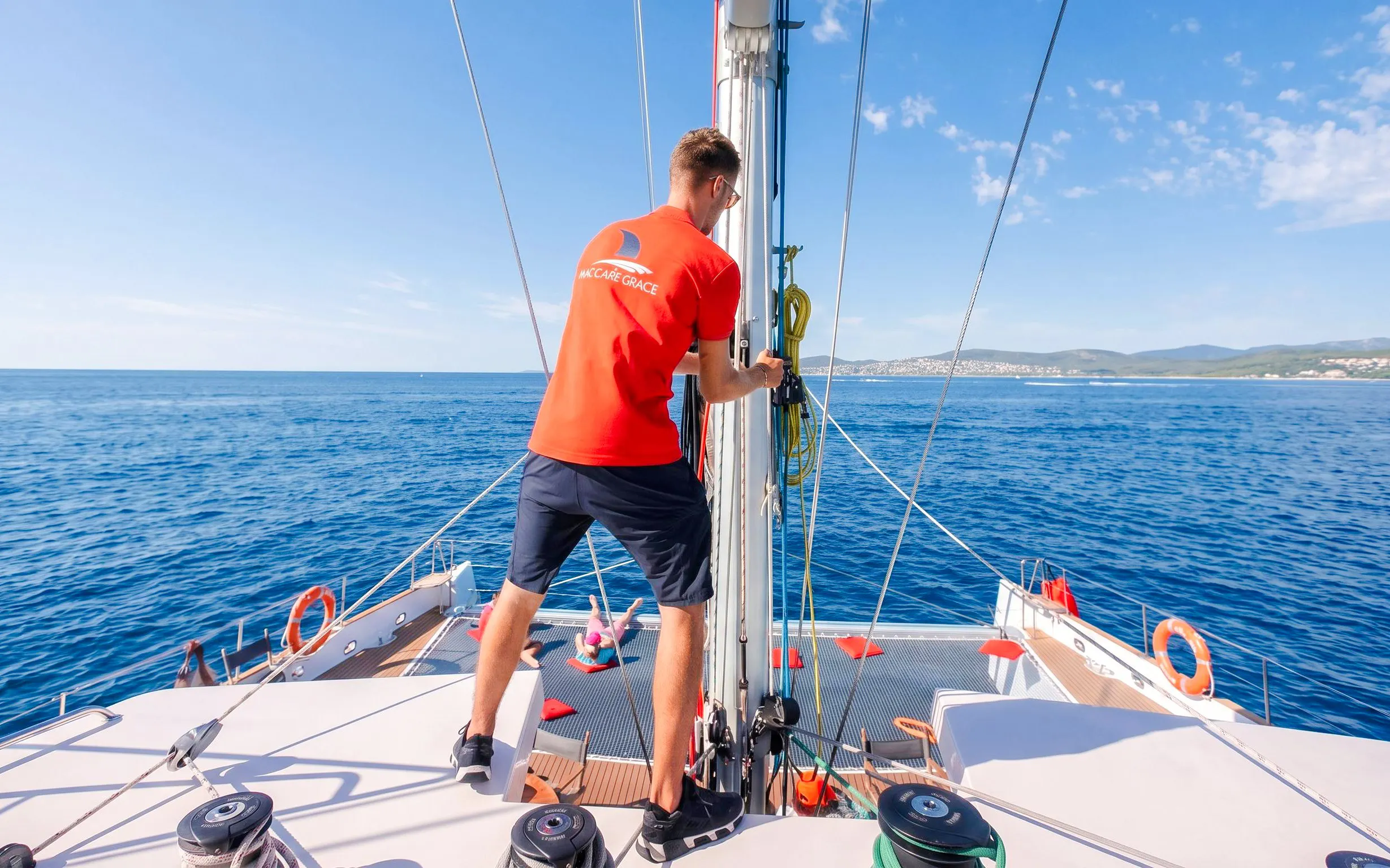 Crew member on catamaran during snorkeling cruise to Villefranche Bay.