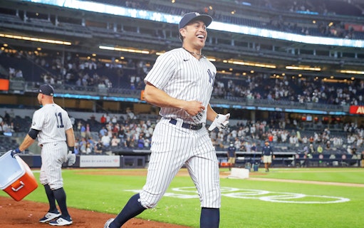 Baseball player in Yankees uniform on field during New York Yankees vs Boston Red Sox game.