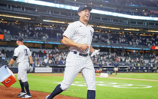 Baseball player in Yankees uniform on field during New York Yankees vs Boston Red Sox game.