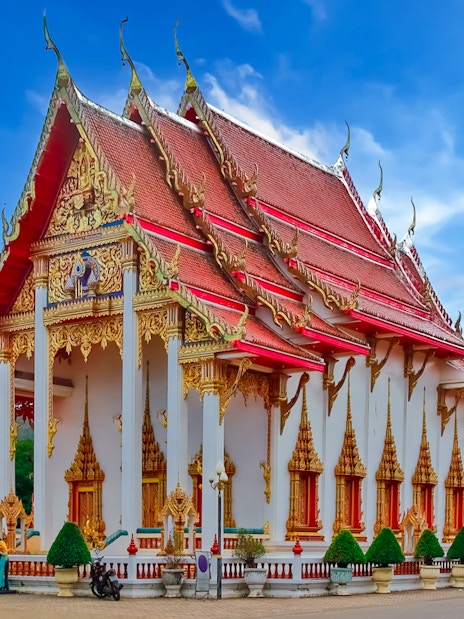 Wat Chalong temple with ornate red and gold roof, Phuket, Thailand.