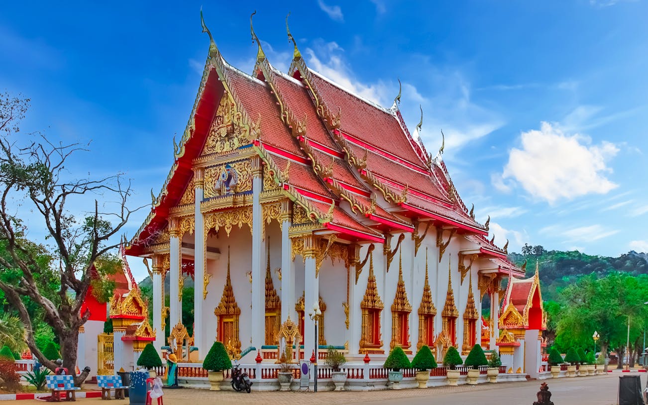 Wat Chalong temple with ornate red and gold roof, Phuket, Thailand.