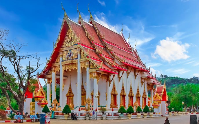 Wat Chalong temple with ornate red and gold roof, Phuket, Thailand.