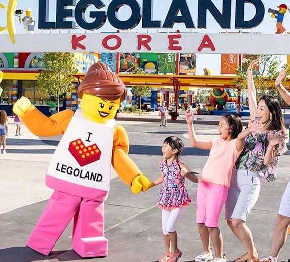 Family enjoying with Lego character at Legoland Korea Resort entrance.