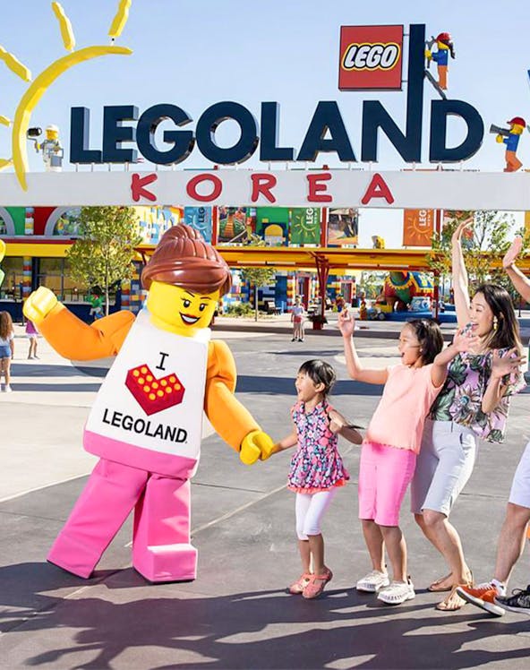 Family enjoying with Lego character at Legoland Korea Resort entrance.
