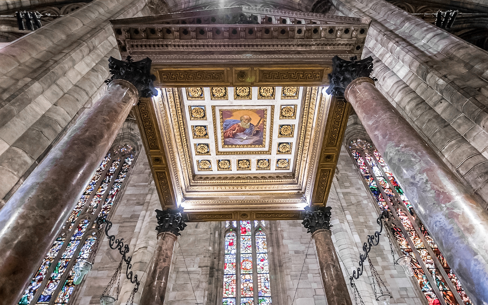 Ceiling and stained glass windows inside Duomo Cathedral, Milan.