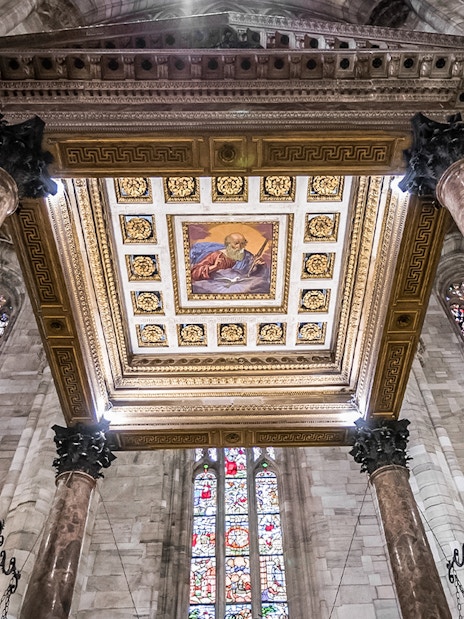 Ceiling and stained glass windows inside Duomo Cathedral, Milan.