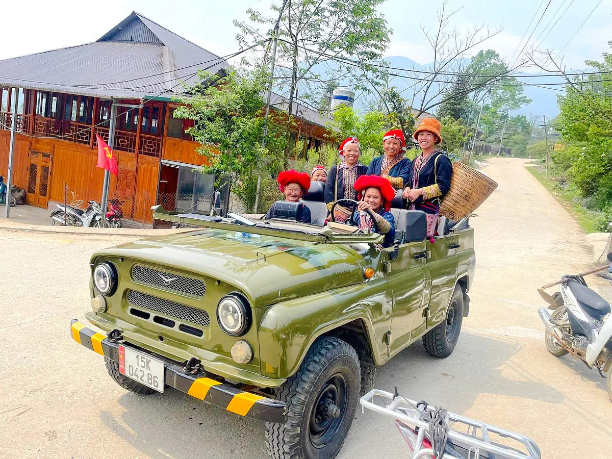 Jeep tour with locals in traditional attire, Sapa, Vietnam.