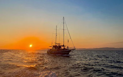 Sunset cruise on Athens Riviera with sailboat, wine, and snacks.