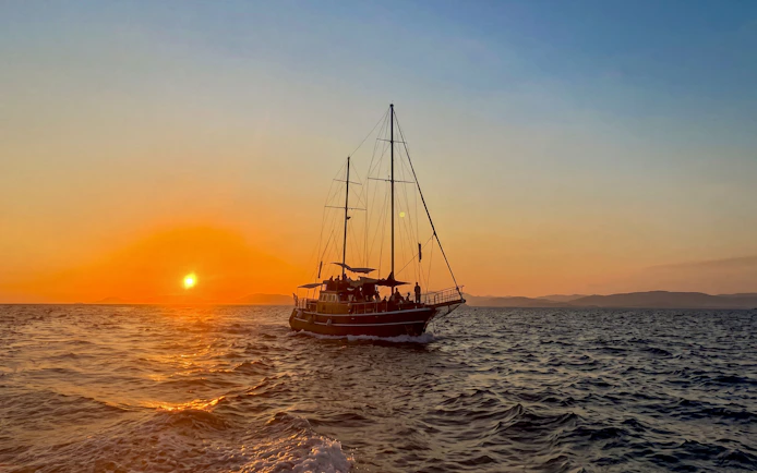 Sunset cruise on Athens Riviera with sailboat, wine, and snacks.