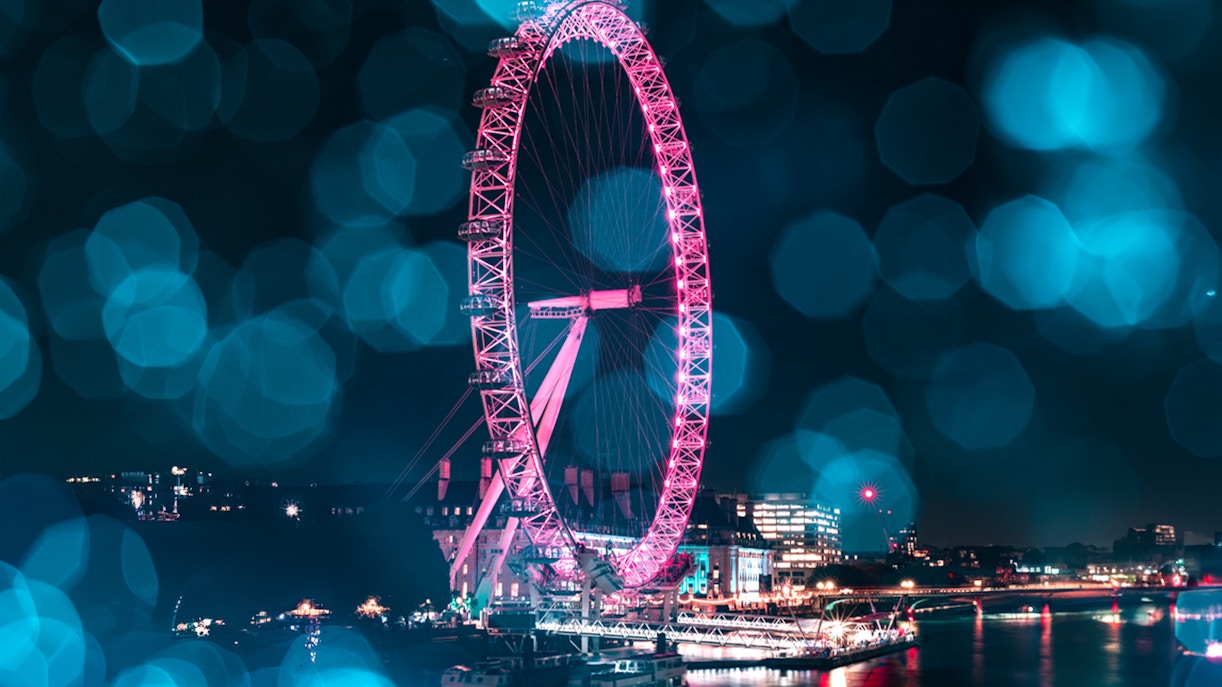 London Eye lit up at night during Christmas, viewed from the Thames, part of The Original Tour London 24Hr Pass.