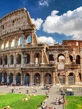Colosseum in Rome with tourists exploring the ancient amphitheater.
