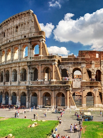 Colosseum in Rome with tourists exploring the ancient amphitheater.